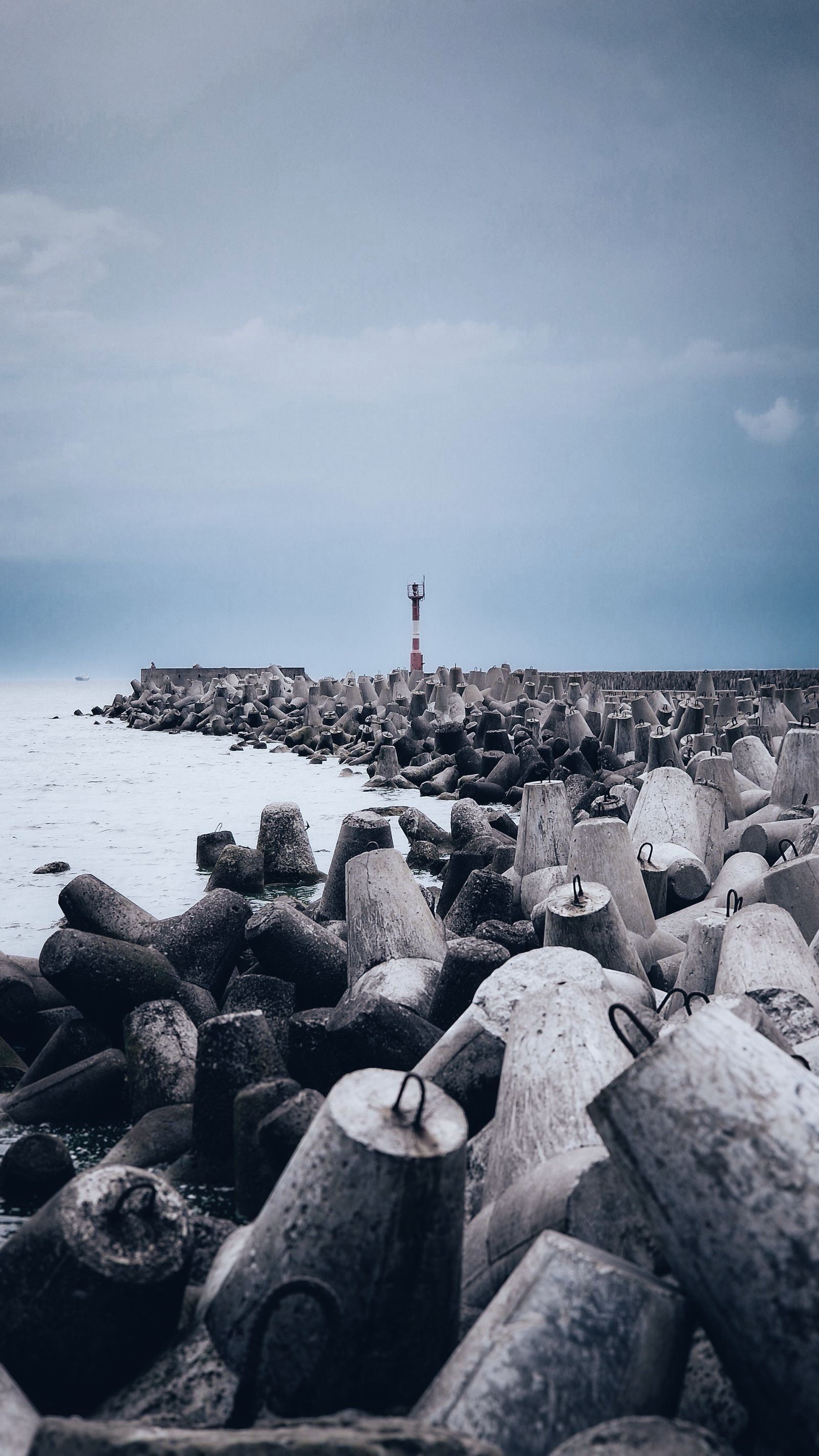 Concrete breakwater blocks by the sea