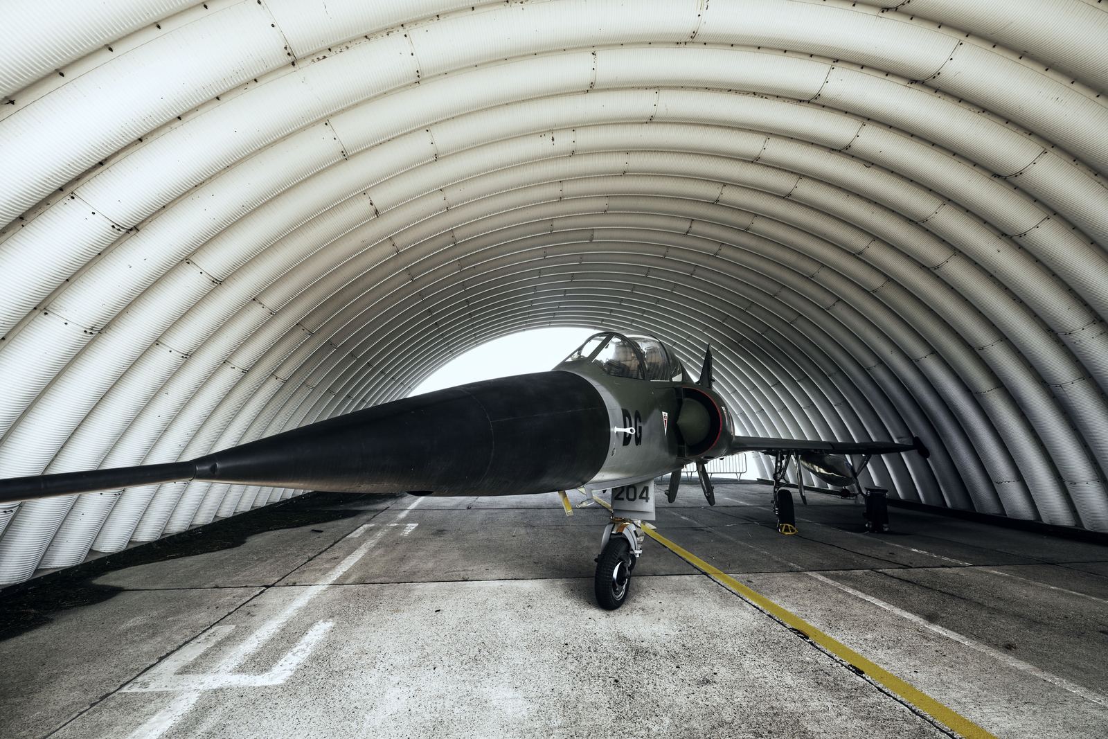 A fighter aircraft inside a hardened aircraft shelter